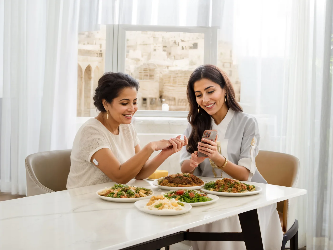 Two women sharing a home-cooked meal; one wears a Sibionics GS1 sensor on her arm while they look at the phone